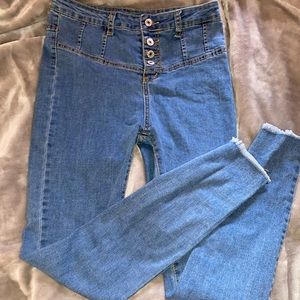 Button up closure high waisted jeans fringe detail